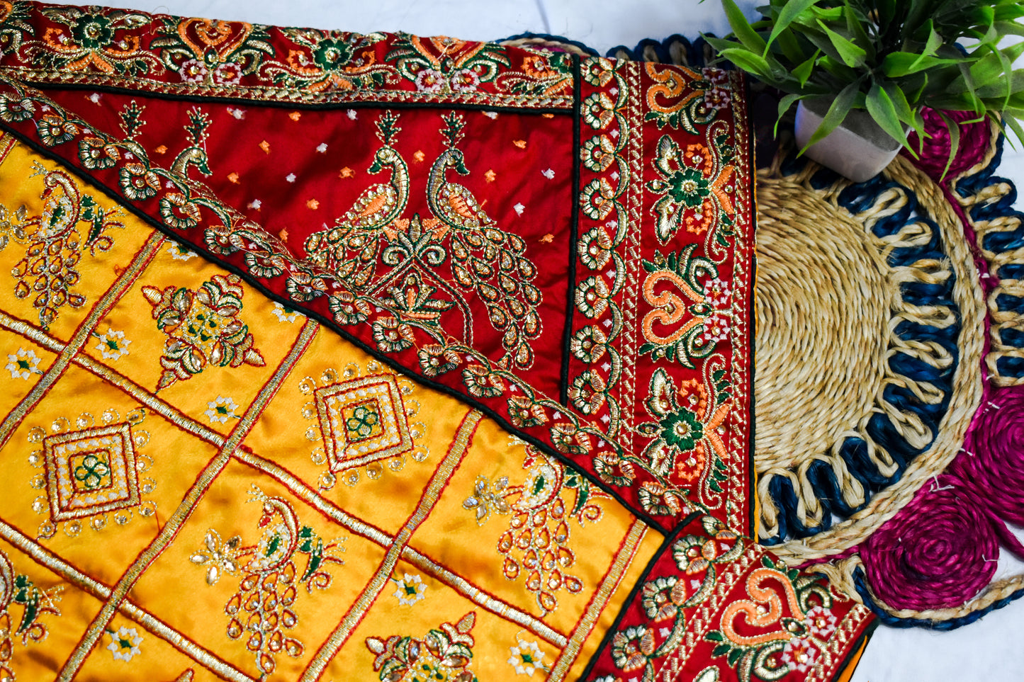 YELLOW SATIN SILK SAREE WITH HEAVY RED BORDER.