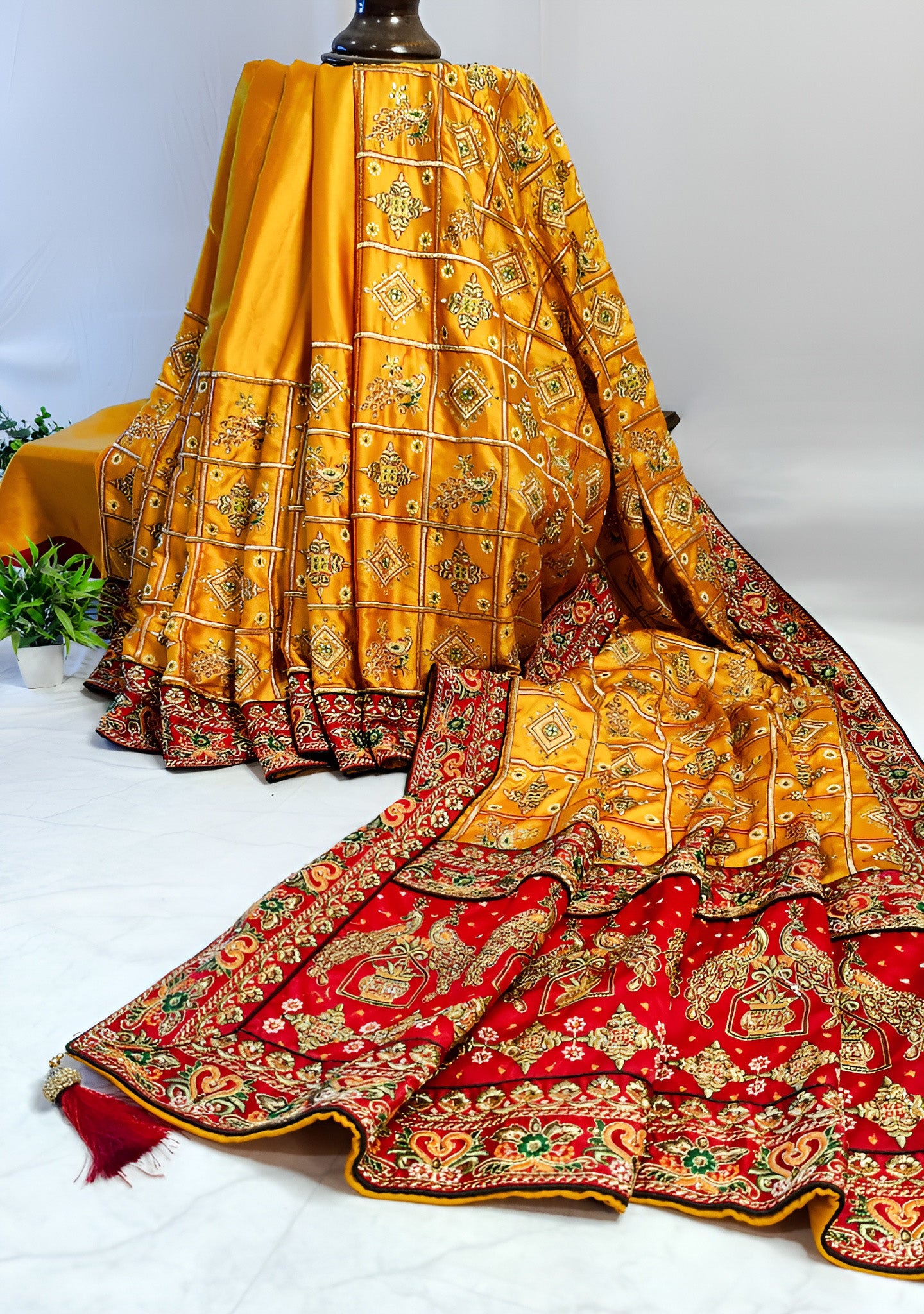 YELLOW SATIN SILK SAREE WITH HEAVY RED BORDER.