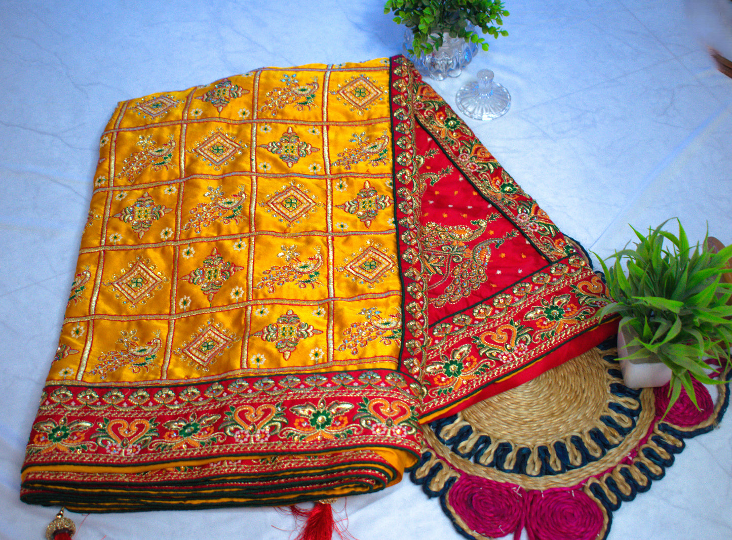 YELLOW SATIN SILK SAREE WITH HEAVY RED BORDER.