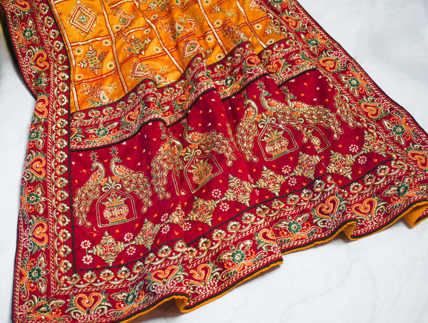 YELLOW SATIN SILK SAREE WITH HEAVY RED BORDER.