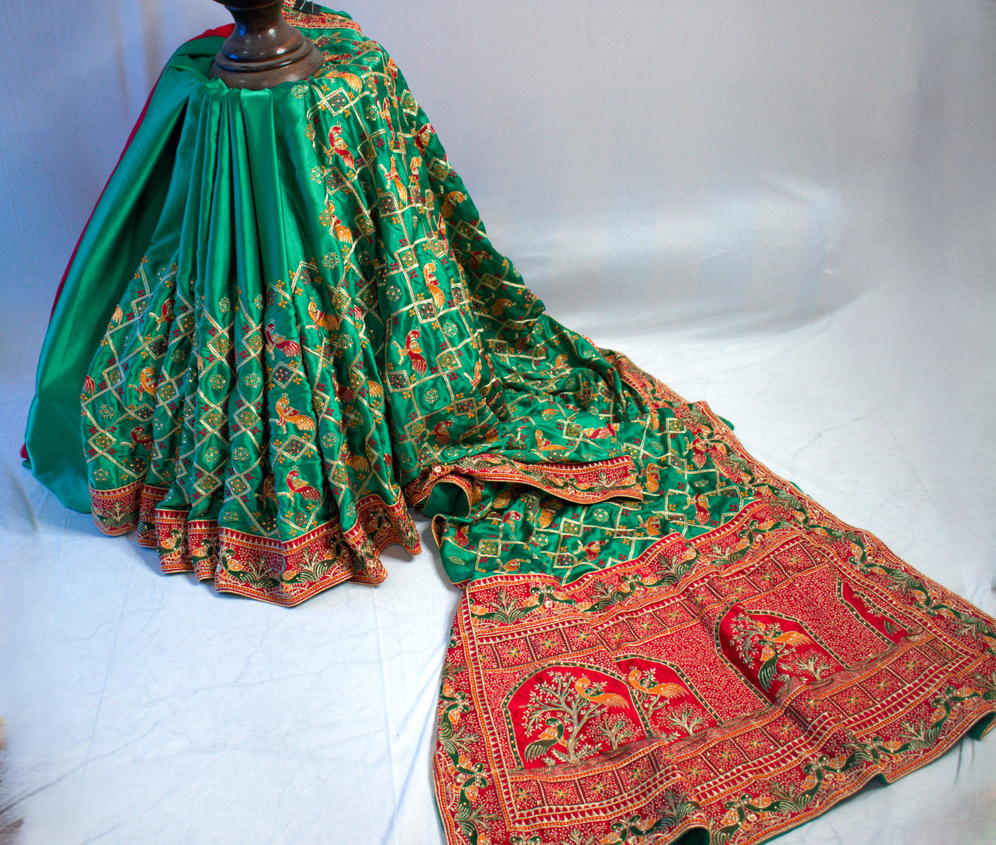 GREEN SATIN SILK SAREE WITH RED BORDER.