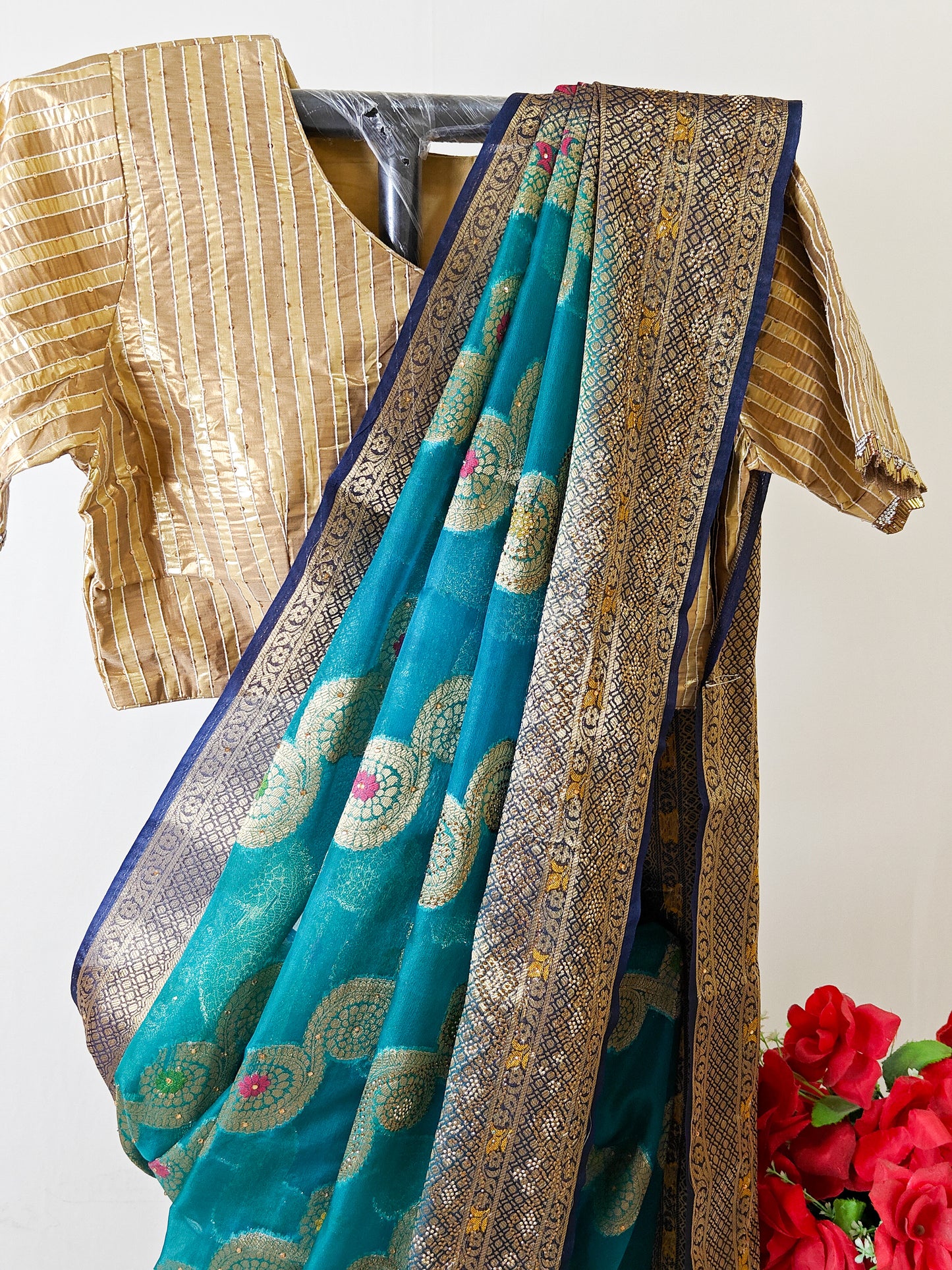 TEAL BLUE ORGANZA SILK SAREE WITH INTRICATE DARK BLUE AND GOLDEN ZARI WEAVING.