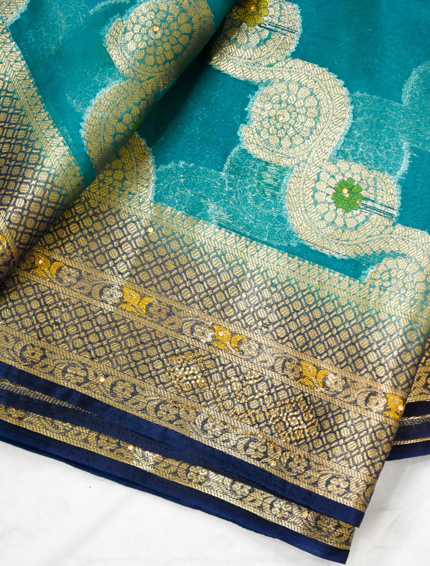 TEAL BLUE ORGANZA SILK SAREE WITH INTRICATE DARK BLUE AND GOLDEN ZARI WEAVING.