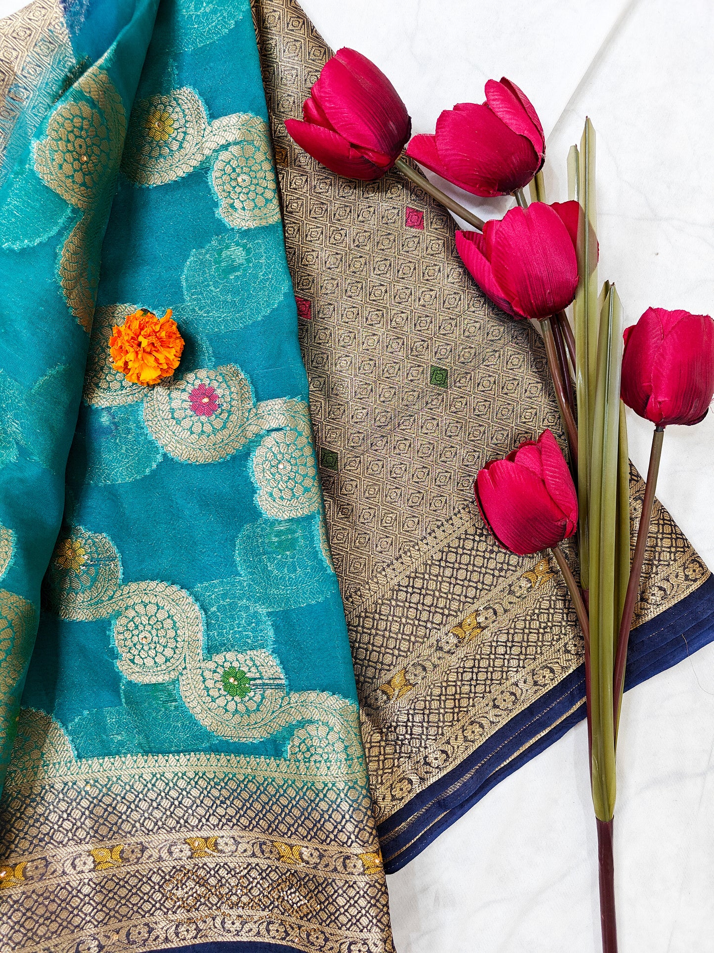 TEAL BLUE ORGANZA SILK SAREE WITH INTRICATE DARK BLUE AND GOLDEN ZARI WEAVING.