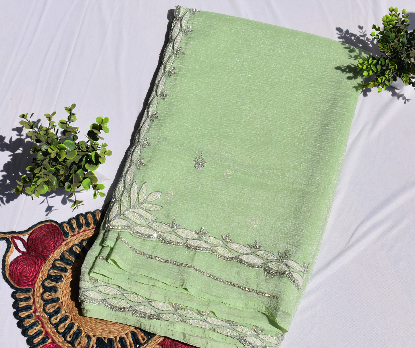 PASTEL MINT GREEN CRUSHED CHIFFON SAREE WITH INTRICATE EMBROIDERY BORDER.