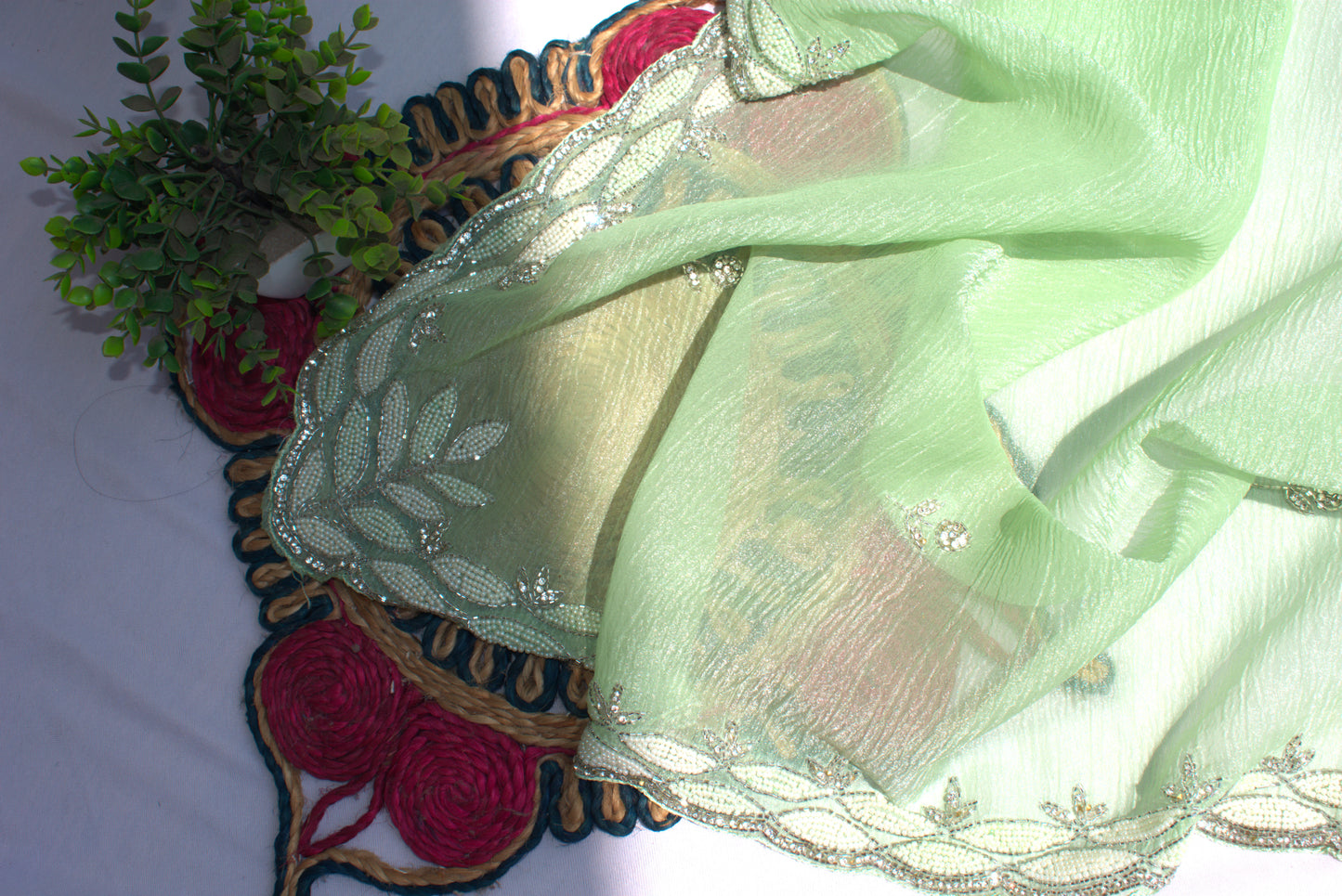 PASTEL MINT GREEN CRUSHED CHIFFON SAREE WITH INTRICATE EMBROIDERY BORDER.
