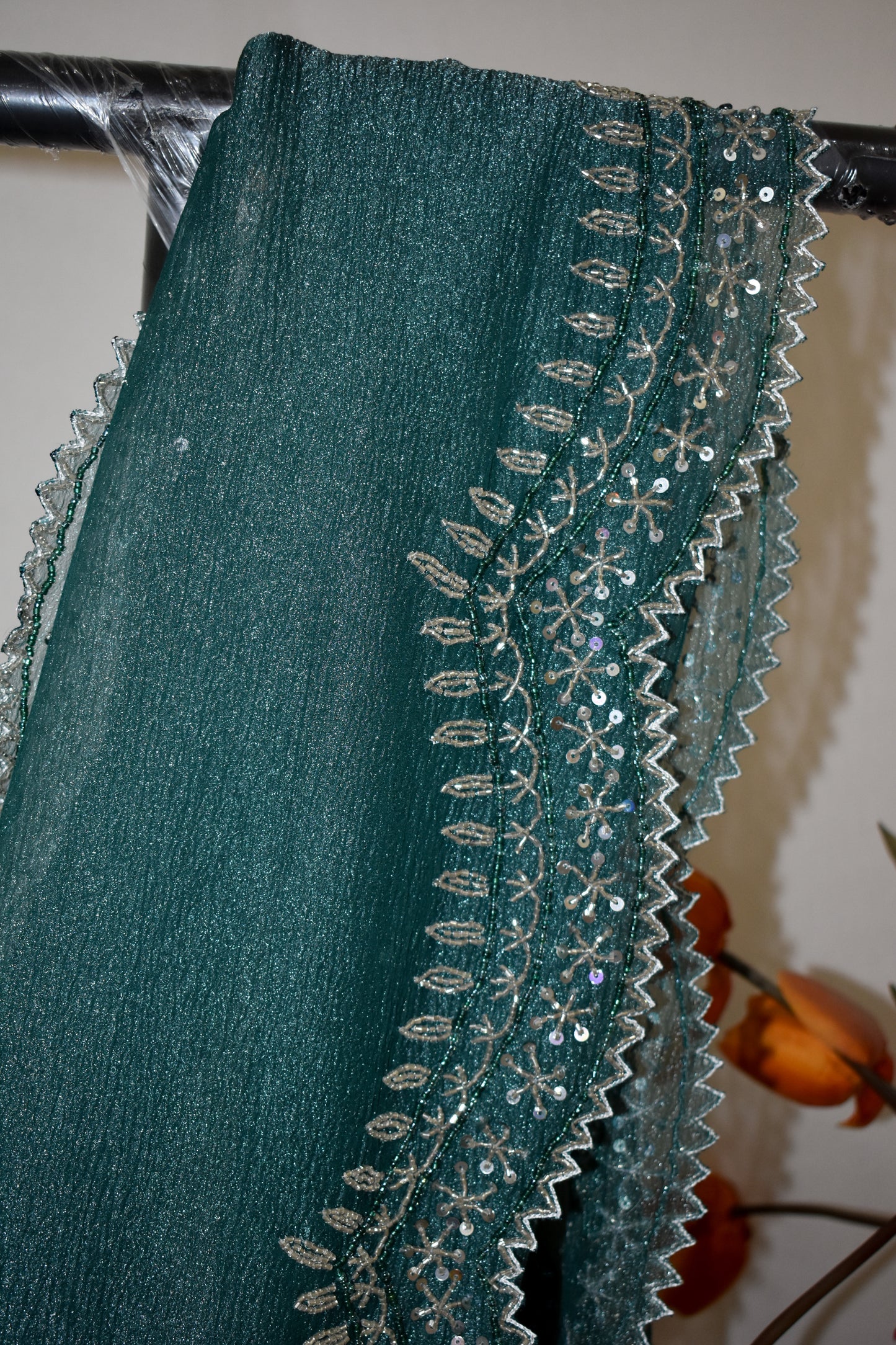 DARK GREY CRUSHED CHIFFON SAREE WITH HAND EMBROIDERED BORDER.