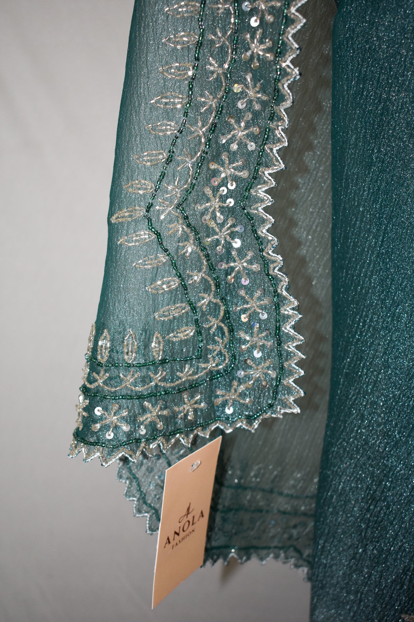 DARK GREY CRUSHED CHIFFON SAREE WITH HAND EMBROIDERED BORDER.