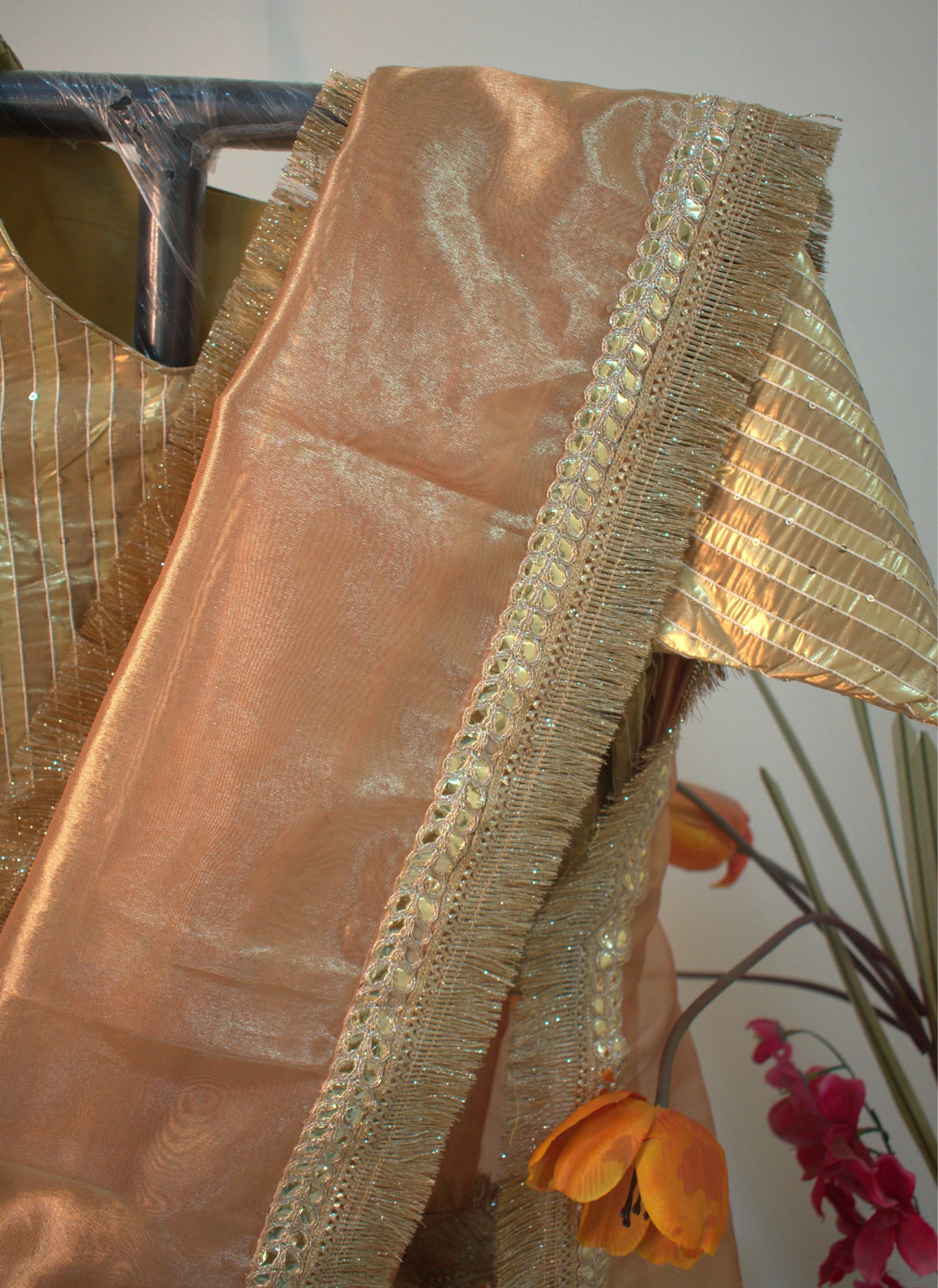 PURE TISSUE GOLD SAREE WITH FRINGE DETAILING.