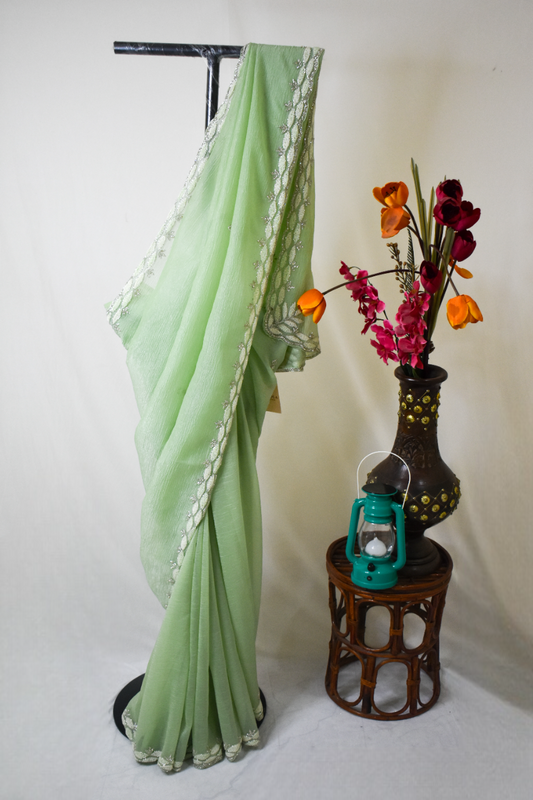 PASTEL MINT GREEN CRUSHED CHIFFON SAREE WITH INTRICATE EMBROIDERY BORDER.