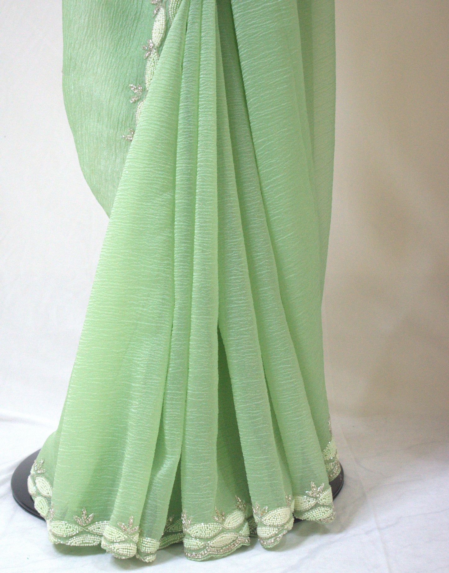 PASTEL MINT GREEN CRUSHED CHIFFON SAREE WITH INTRICATE EMBROIDERY BORDER.