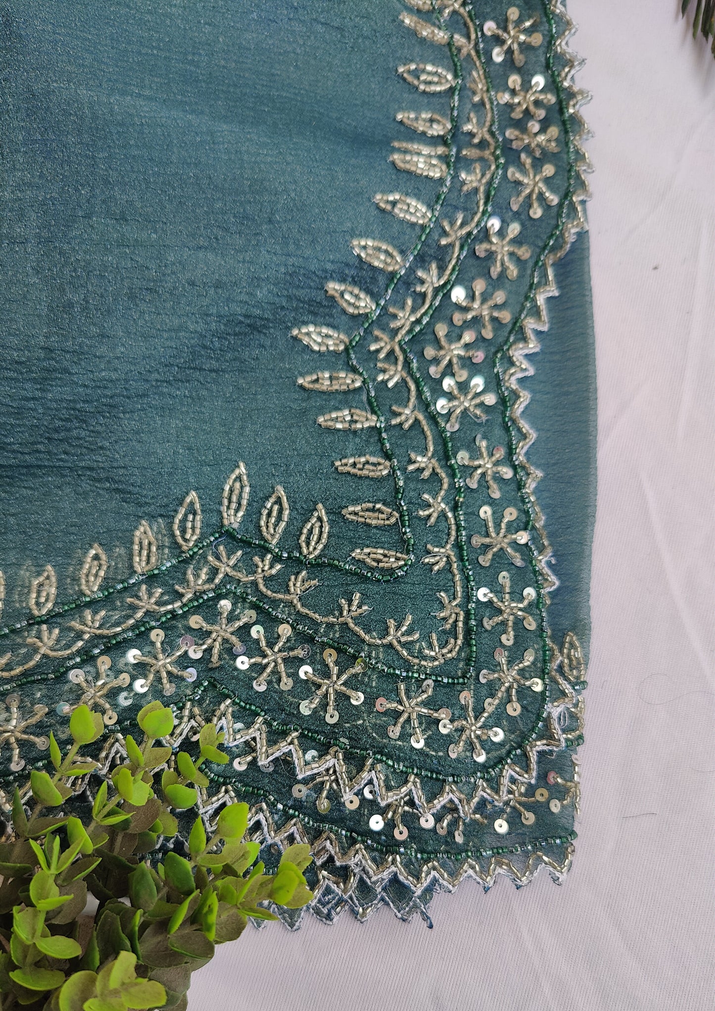 DARK GREY CRUSHED CHIFFON SAREE WITH HAND EMBROIDERED BORDER.