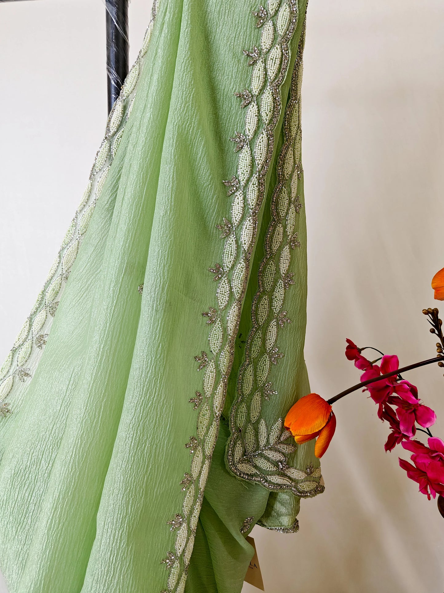 PASTEL MINT GREEN CRUSHED CHIFFON SAREE WITH INTRICATE EMBROIDERY BORDER.