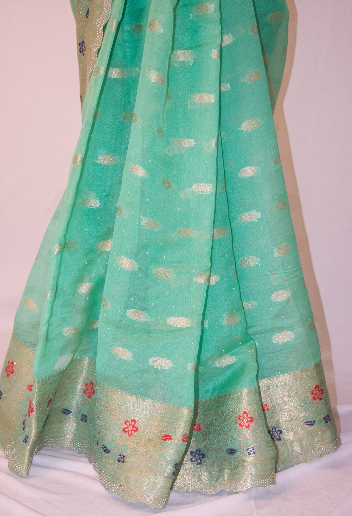 SEA GREEN SILK BLEND SAREE WITH ZARI, FLORAL BORDER & SWAROVSKI WORK.