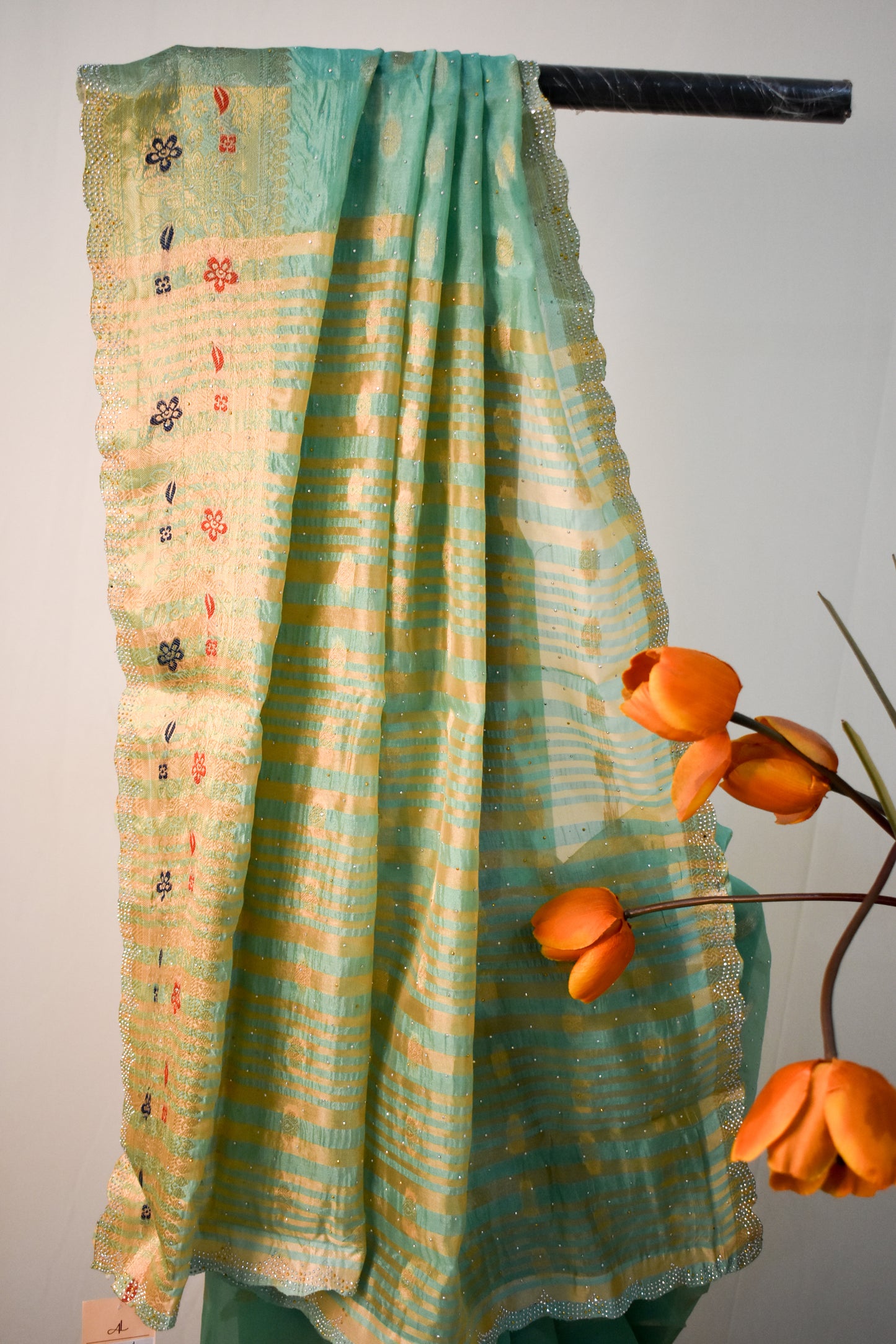 SEA GREEN SILK BLEND SAREE WITH ZARI, FLORAL BORDER & SWAROVSKI WORK.