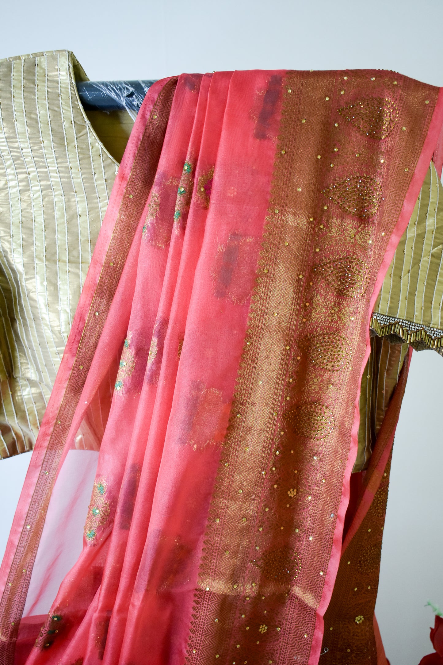 CRIMSON PINK ORGANZA SILK SAREE WITH ZARI WEAVE & BEAD DETAILING.