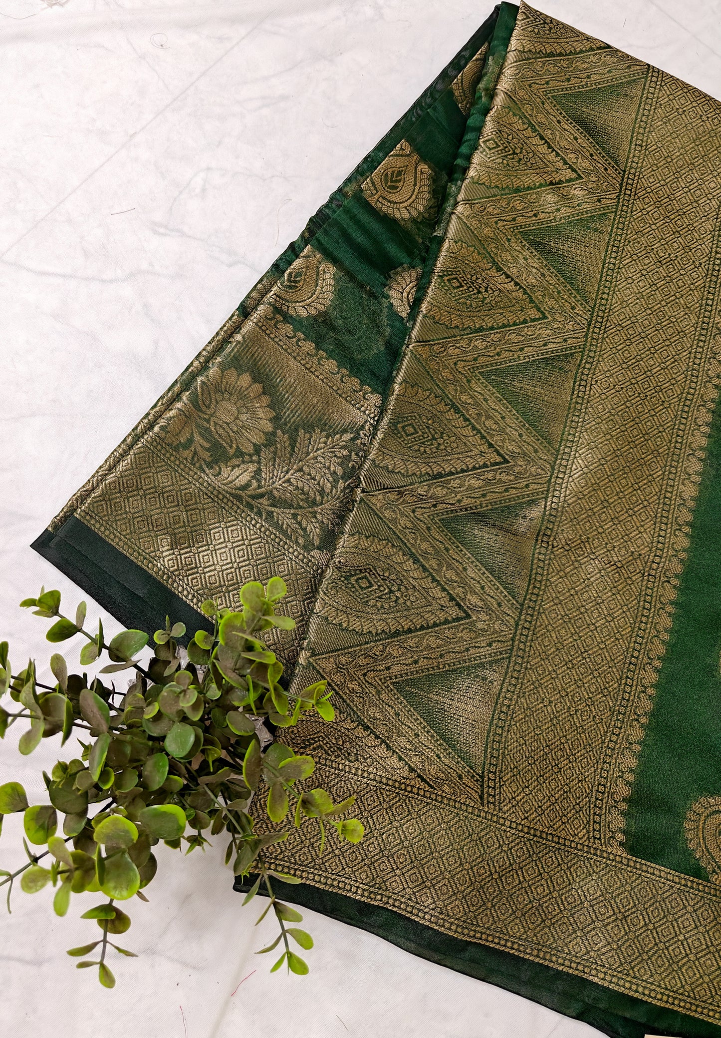DARK BOTTLE GREEN SILK BLEND SAREE WITH INTRICATE GOLDEN ZARI WEAVING.