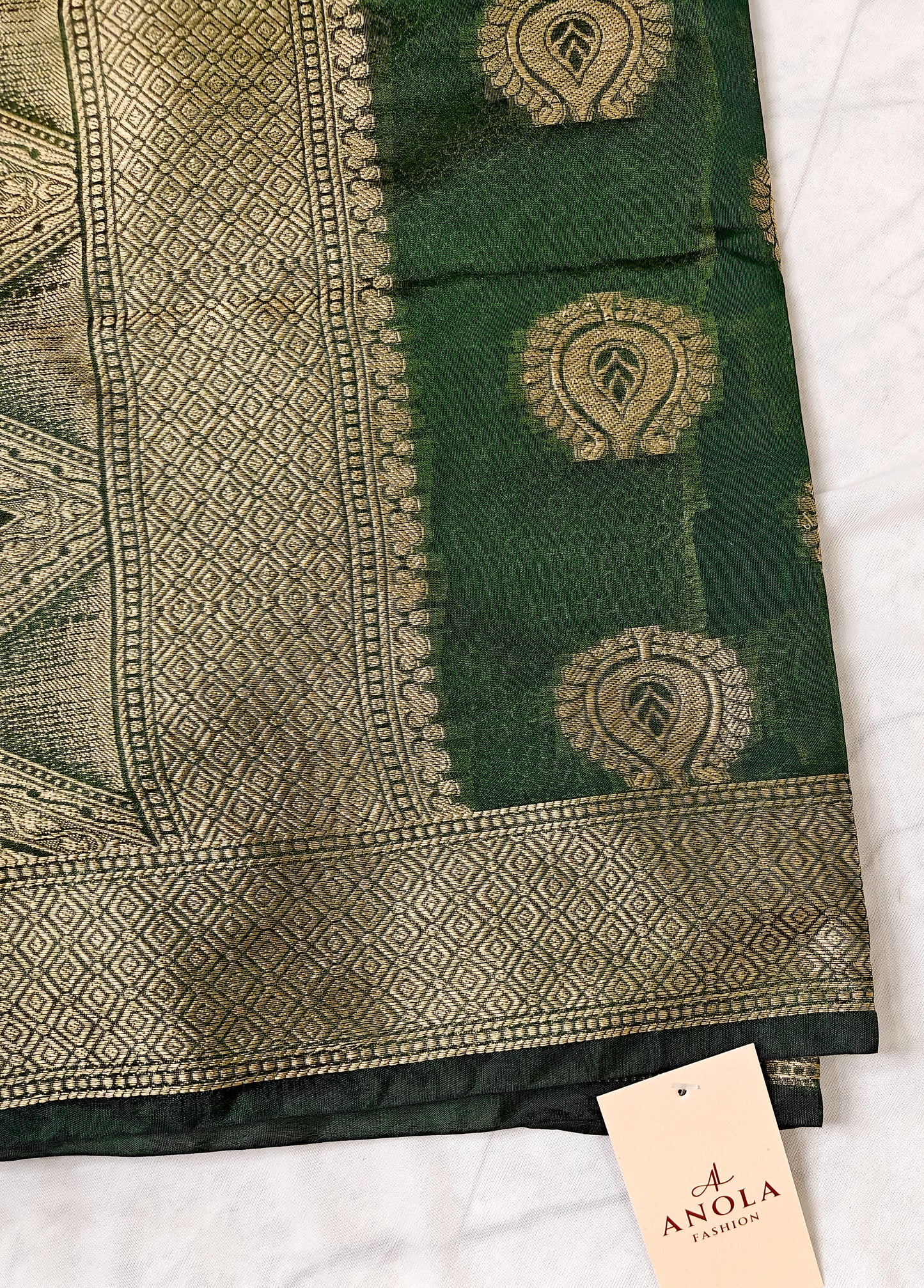 DARK BOTTLE GREEN SILK BLEND SAREE WITH INTRICATE GOLDEN ZARI WEAVING.