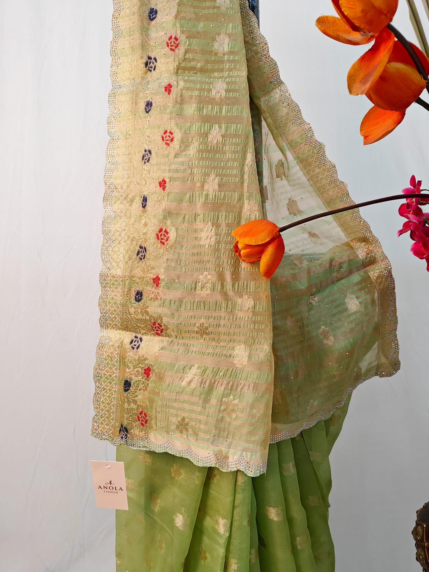 PARROT GREEN SILK BLEND SAREE WITH ZARI FLORAL BORDER & SWAROVSKI DETAILING.