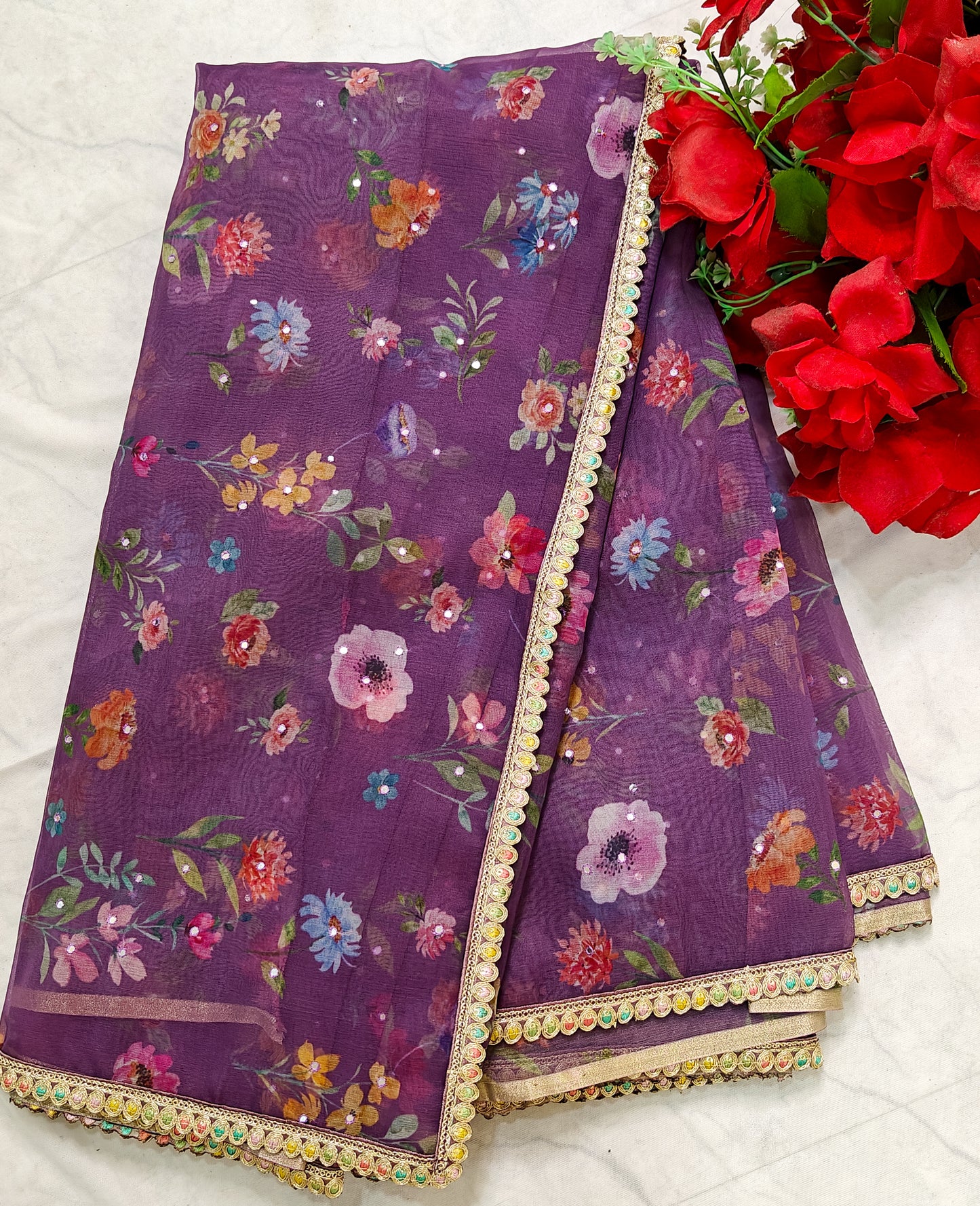 PURPLE ORGANZA FLORAL PRINT SAREE WITH MULTICOLOUR SEQUIN BORDER.
