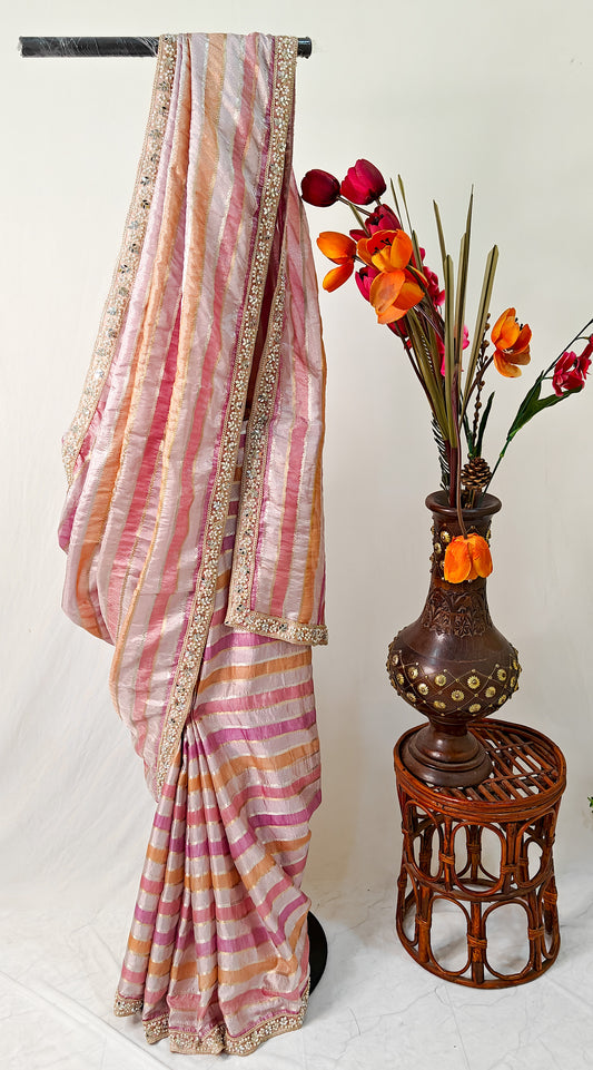 ORGANZA STRIPED SAREE IN PURPLE, LAVENDER, PINK, PEACH & GOLD WITH EMBELLISHED BORDER.