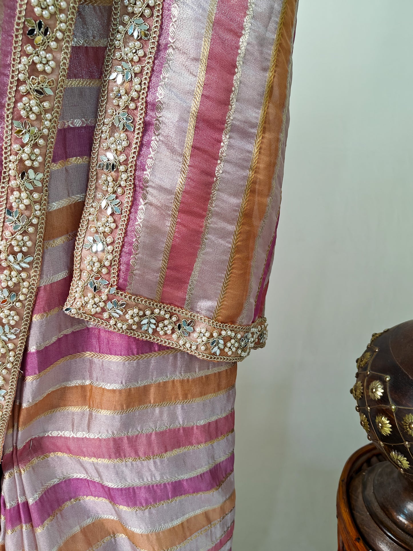 ORGANZA STRIPED SAREE IN PURPLE, LAVENDER, PINK, PEACH & GOLD WITH EMBELLISHED BORDER.