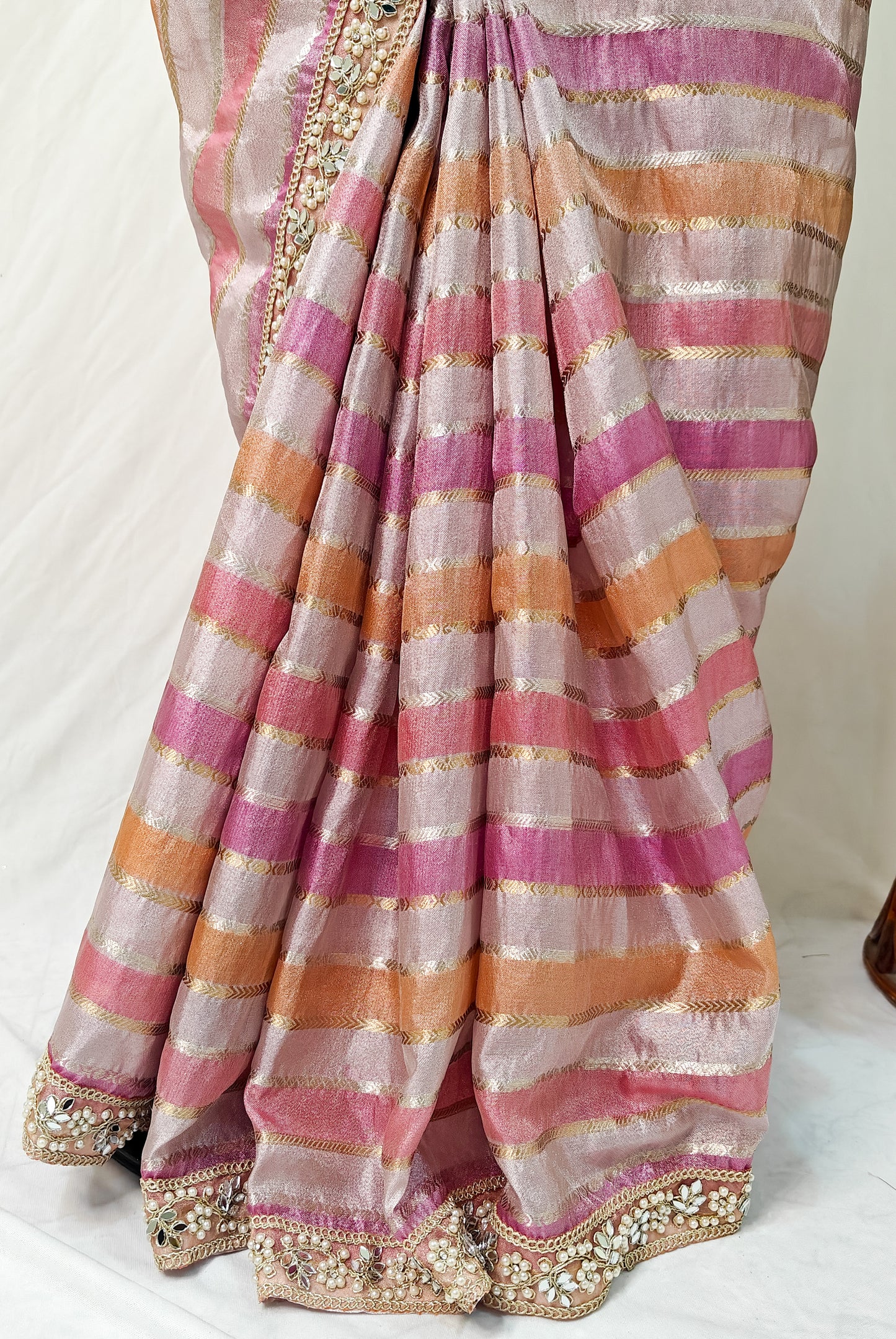 ORGANZA STRIPED SAREE IN PURPLE, LAVENDER, PINK, PEACH & GOLD WITH EMBELLISHED BORDER.