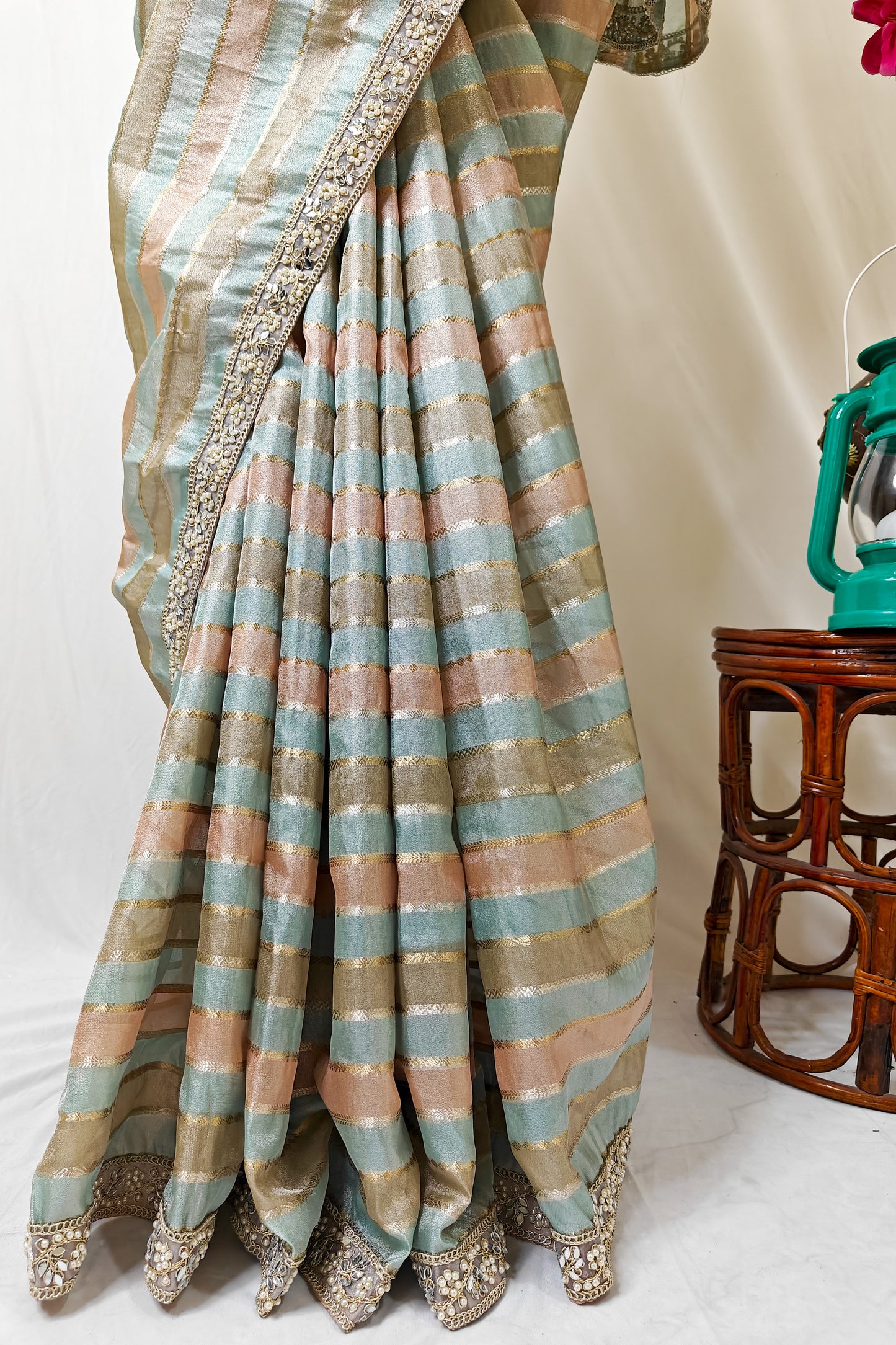 ORGANZA STRIPED SAREE IN SKY-BLUE, PEACH, OLIVE & GOLD WITH EMBELLISHED BORDER.