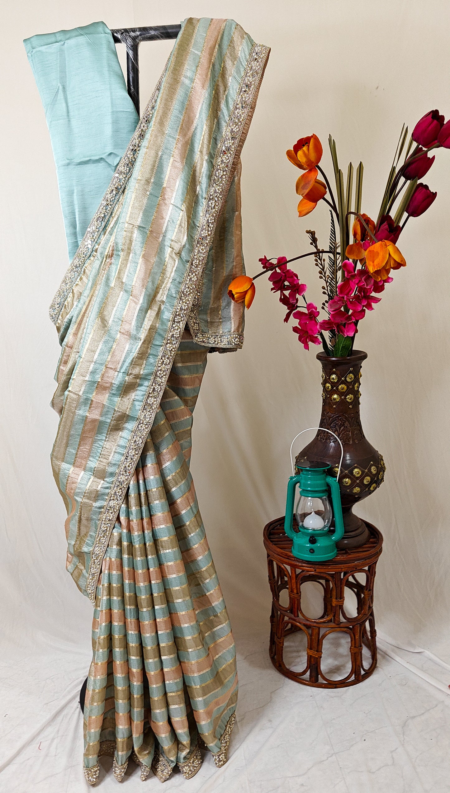 ORGANZA STRIPED SAREE IN SKY-BLUE, PEACH, OLIVE & GOLD WITH EMBELLISHED BORDER.
