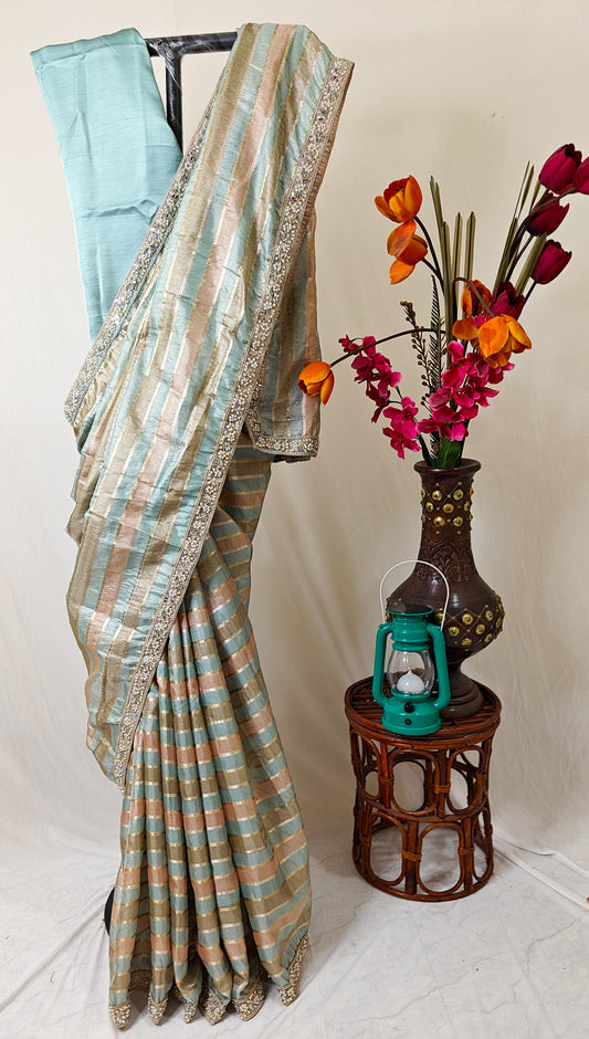 ORGANZA STRIPED SAREE IN SKY-BLUE, PEACH, OLIVE & GOLD WITH EMBELLISHED BORDER.