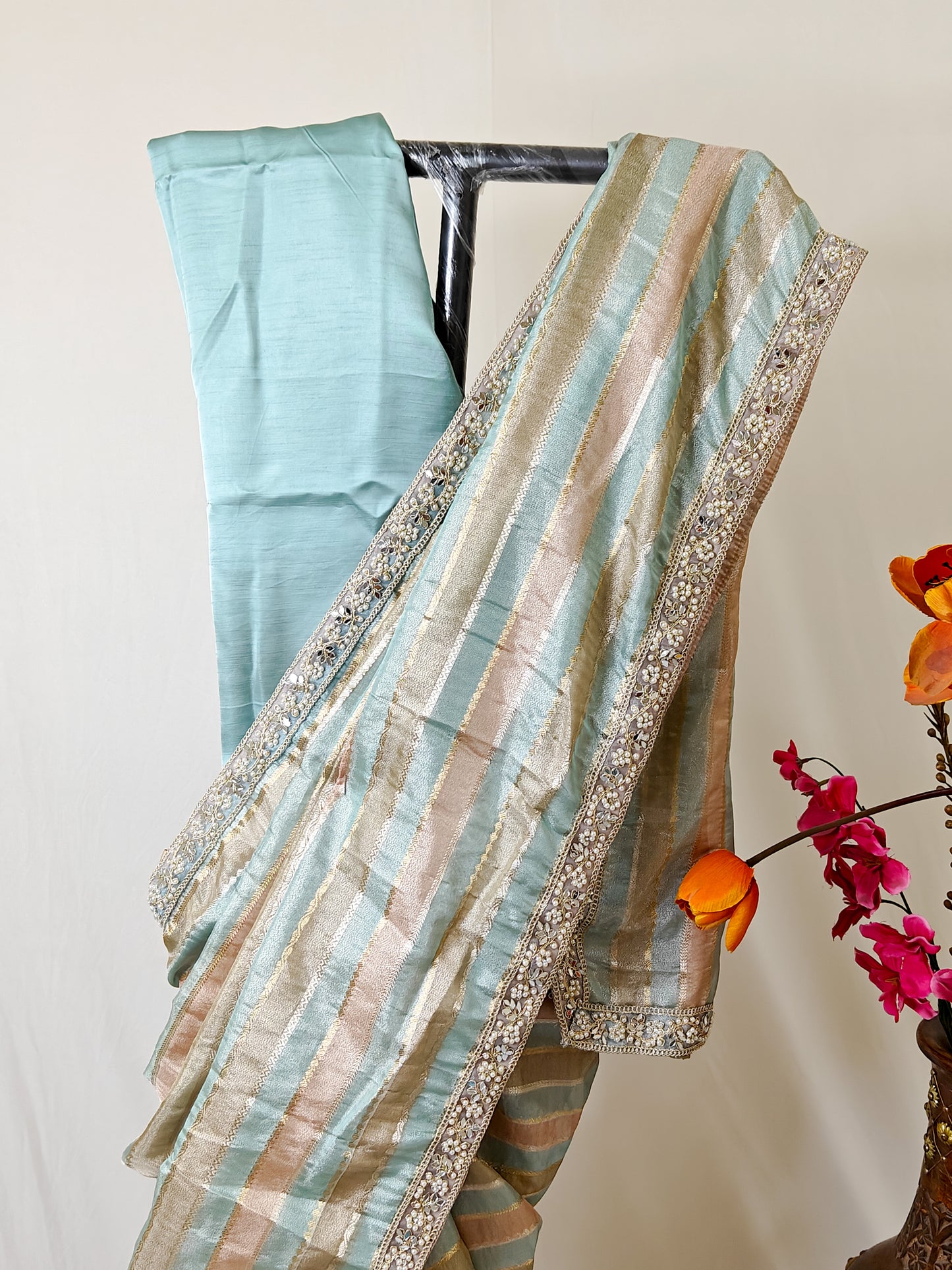 ORGANZA STRIPED SAREE IN SKY-BLUE, PEACH, OLIVE & GOLD WITH EMBELLISHED BORDER.
