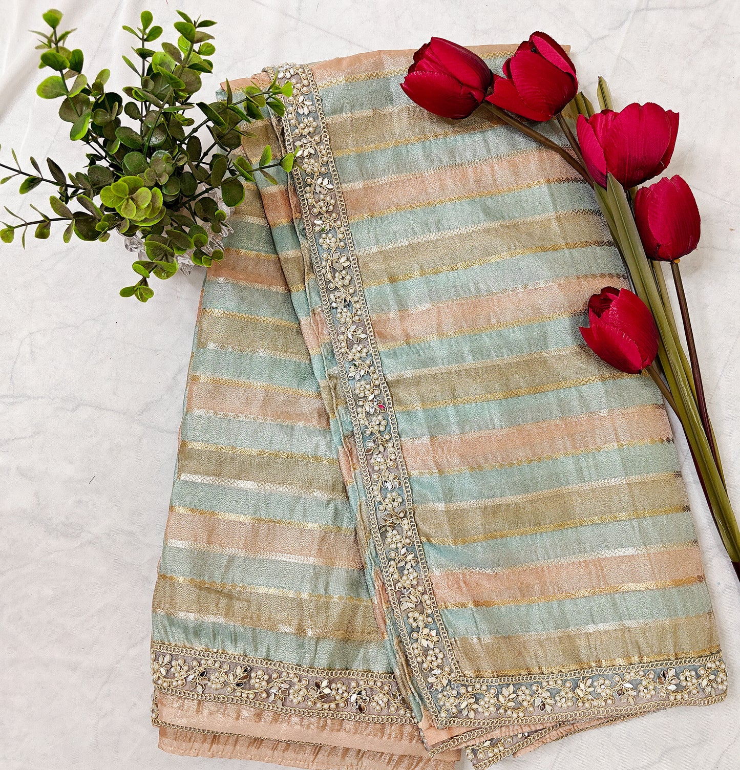 ORGANZA STRIPED SAREE IN SKY-BLUE, PEACH, OLIVE & GOLD WITH EMBELLISHED BORDER.